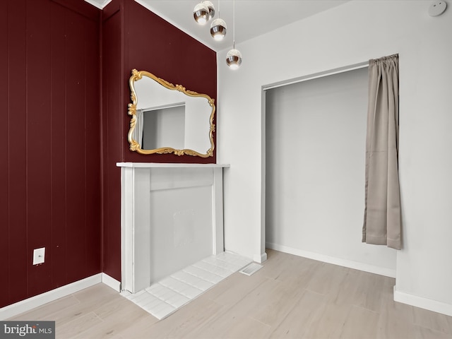 2002 E Preston St, Baltimore, MD 21213 - unfurnished living room featuring wood finished floors and baseboards