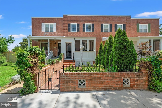 3017 Fulton St, Alexandria, VA 22305 - multi unit property with a fenced front yard, brick siding, a gate, and a porch
