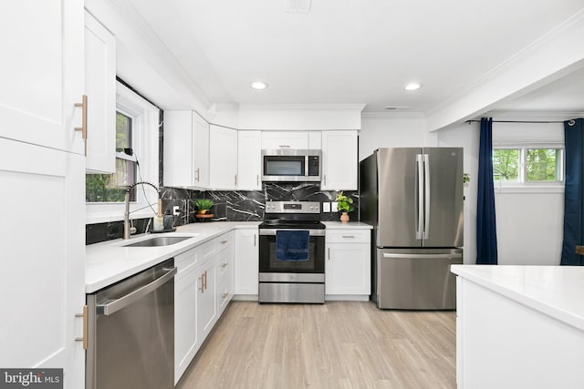 2920 Weisman Rd, Silver Spring, MD 20902 - kitchen featuring appliances with stainless steel finishes, a sink, white cabinetry, light countertops, and ornamental molding