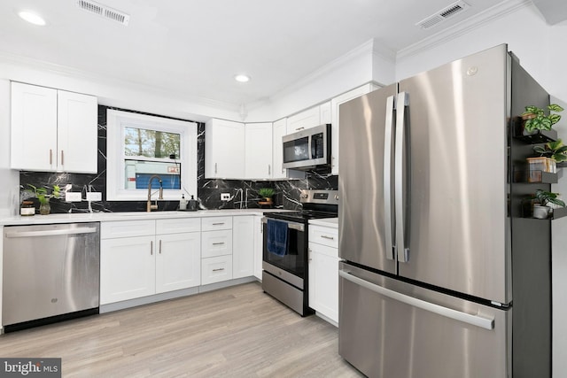 2920 Weisman Rd, Silver Spring, MD 20902 - kitchen with stainless steel appliances, crown molding, white cabinets, recessed lighting, and backsplash