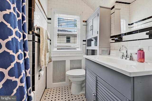 619 Warwick Rd, Baltimore, MD 21229 - bathroom with toilet, vanity, tile walls, and curtained shower