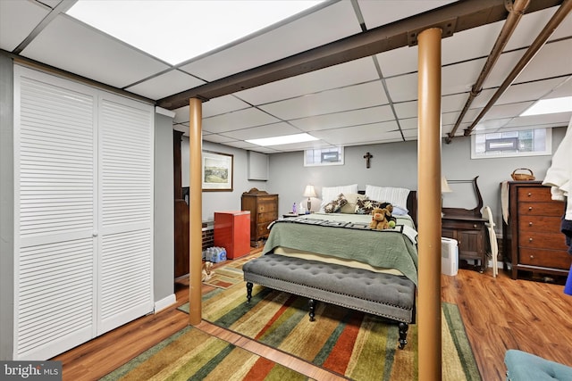 619 Warwick Rd, Baltimore, MD 21229 - bedroom featuring multiple windows, wood finished floors, and a paneled ceiling