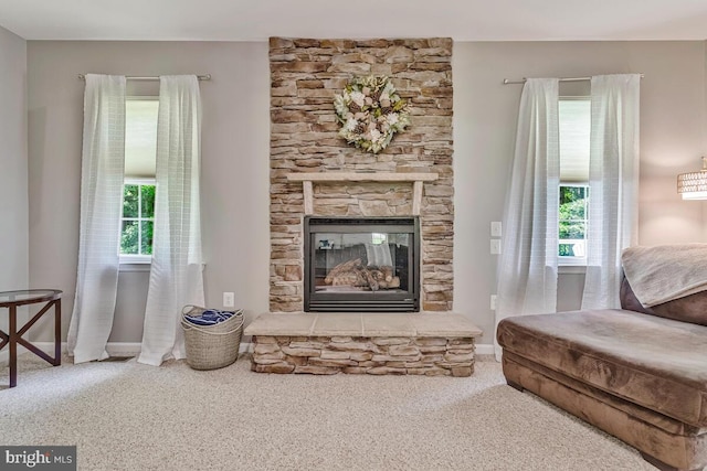 141 Lorins Dr, Huntingtown, MD 20639 - carpeted living room featuring a fireplace and baseboards
