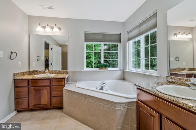 141 Lorins Dr, Huntingtown, MD 20639 - full bathroom with two vanities, a bath, and tile patterned flooring