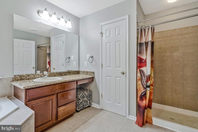 141 Lorins Dr, Huntingtown, MD 20639 - bathroom with tile patterned flooring, tiled shower, vanity, a garden tub, and baseboards