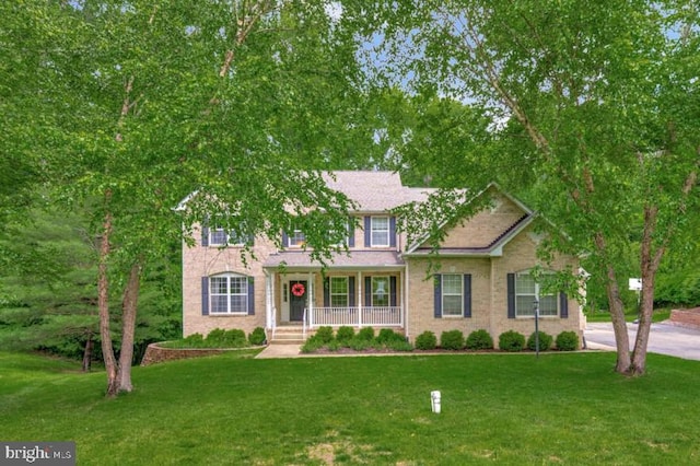 141 Lorins Dr, Huntingtown, MD 20639 - view of front of house with a porch and a front lawn