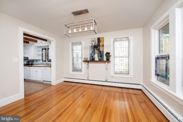 8 S Main St, Stockton, NJ 08559 - unfurnished dining area featuring a baseboard radiator, light wood-type flooring, and baseboards
