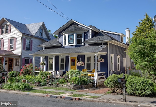 8 S Main St, Stockton, NJ 08559 - view of front of property with covered porch, a shingled roof, and a chimney