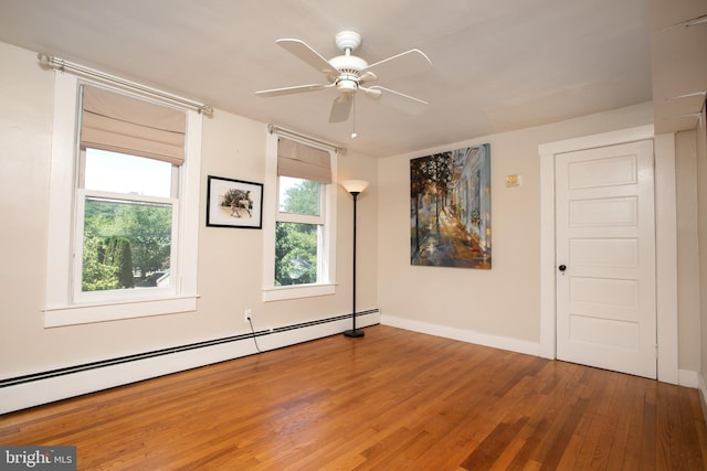 8 S Main St, Stockton, NJ 08559 - spare room with wood finished floors, a baseboard heating unit, a ceiling fan, and baseboards