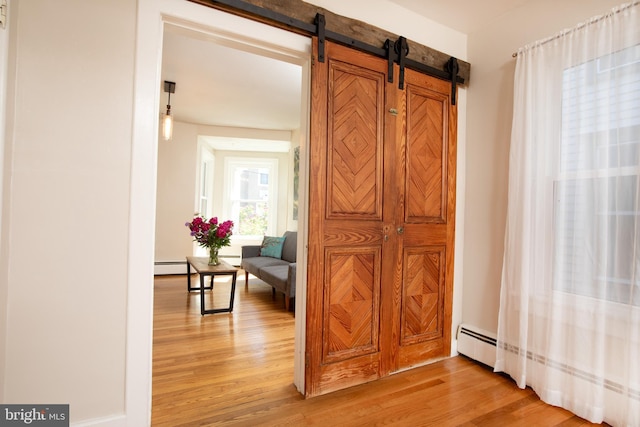 8 S Main St, Stockton, NJ 08559 - hallway featuring light wood-type flooring, a baseboard radiator, and a barn door