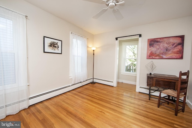 8 S Main St, Stockton, NJ 08559 - sitting room featuring light wood finished floors, a ceiling fan, a baseboard heating unit, and baseboards