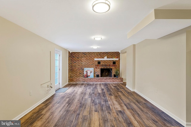 8230 Citadel Pl, Vienna, VA 22180 - unfurnished living room with dark wood-type flooring, brick wall, a fireplace, and baseboards