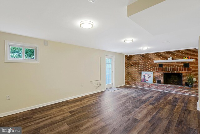 8230 Citadel Pl, Vienna, VA 22180 - unfurnished living room with dark wood-type flooring, baseboards, a fireplace, and brick wall