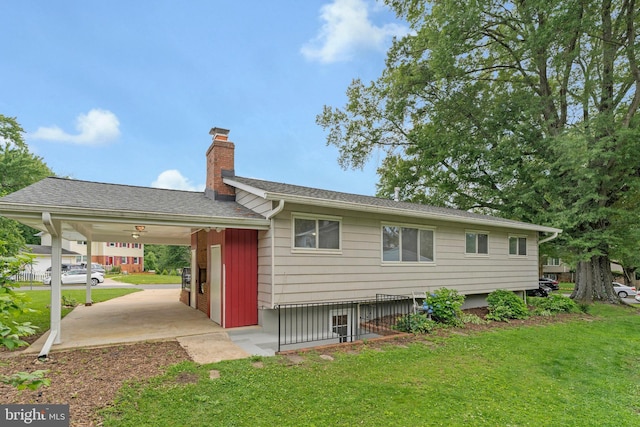 8230 Citadel Pl, Vienna, VA 22180 - rear view of property featuring a chimney, a lawn, and an attached carport