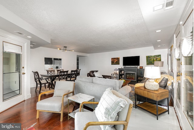 1040 Deer Ridge Dr Unit 101, Baltimore, MD 21210 - living area with a textured ceiling and wood finished floors