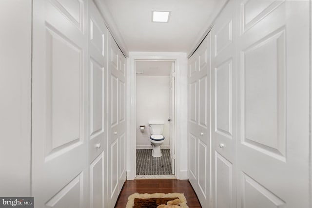 1040 Deer Ridge Dr Unit 101, Baltimore, MD 21210 - bathroom featuring wood finished floors, toilet, a closet, and baseboards