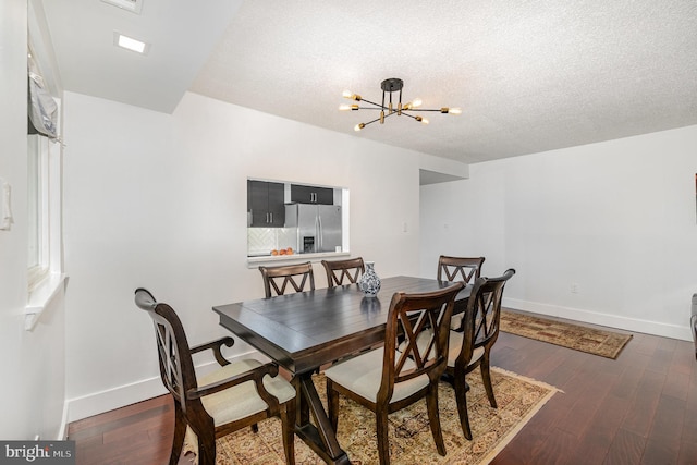 1040 Deer Ridge Dr Unit 101, Baltimore, MD 21210 - dining room featuring a chandelier, baseboards, a textured ceiling, and dark wood-style flooring