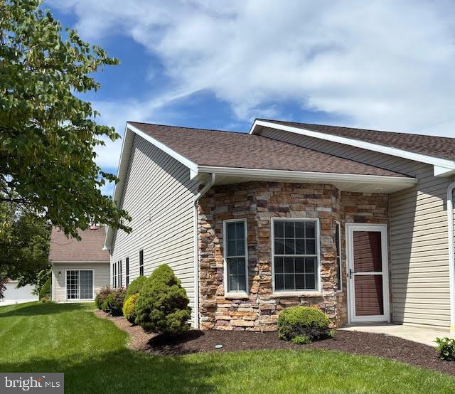 636 Northland Dr, Hanover, PA 17331 - view of front of property with stone siding, a front lawn, and a shingled roof