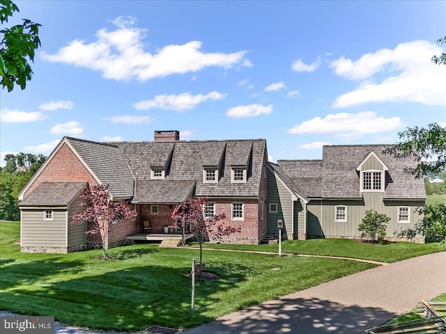 103 Orchard Hill Ln, Elverson, PA 19520 - view of front facade featuring a chimney, a front yard, and brick siding