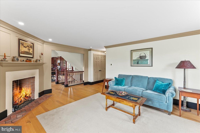 103 Orchard Hill Ln, Elverson, PA 19520 - living area with crown molding, light wood-type flooring, a fireplace with flush hearth, and recessed lighting