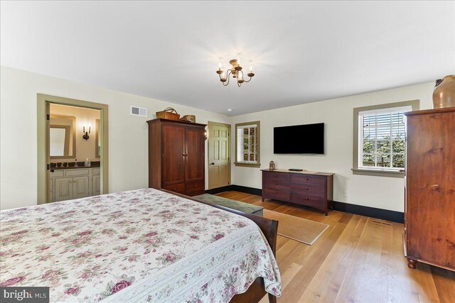 103 Orchard Hill Ln, Elverson, PA 19520 - bedroom featuring light wood finished floors, a chandelier, baseboards, and ensuite bath