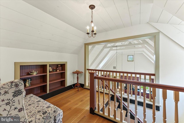 103 Orchard Hill Ln, Elverson, PA 19520 - living area with a chandelier, lofted ceiling, wood finished floors, an upstairs landing, and built in shelves