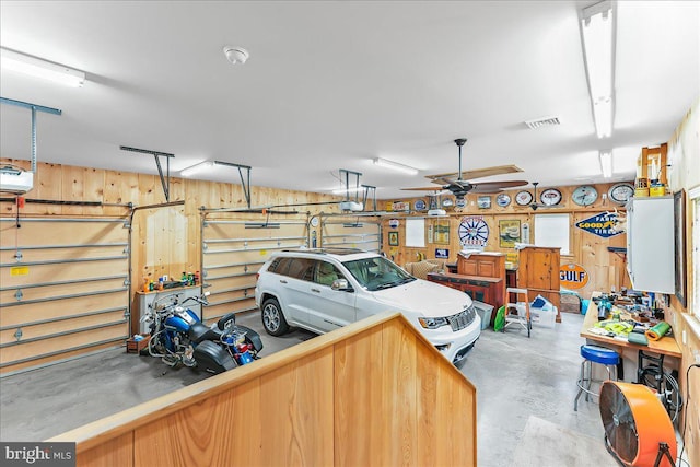 103 Orchard Hill Ln, Elverson, PA 19520 - garage featuring a garage door opener and wood walls