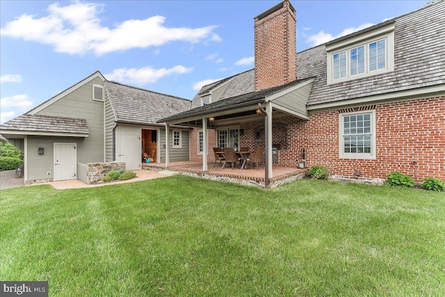 103 Orchard Hill Ln, Elverson, PA 19520 - rear view of house with a chimney, a yard, brick siding, and a patio