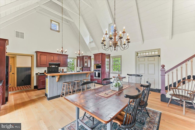 103 Orchard Hill Ln, Elverson, PA 19520 - dining area with a chandelier, high vaulted ceiling, light wood-type flooring, beam ceiling, and stairs