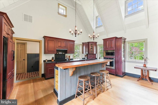103 Orchard Hill Ln, Elverson, PA 19520 - kitchen with built in appliances, a chandelier, light wood-type flooring, high vaulted ceiling, and beam ceiling
