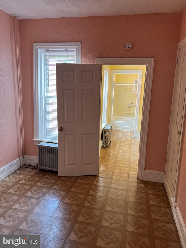 735 Locust St, Reading, PA 19604 - foyer entrance with radiator heating unit, radiator, light flooring, and baseboards