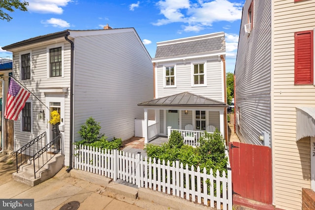 330 N Patrick St, Alexandria, VA 22314 - view of front of home featuring covered porch, a standing seam roof, a shingled roof, and metal roof