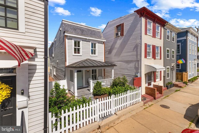 330 N Patrick St, Alexandria, VA 22314 - view of front facade with a porch, cooling unit, and a standing seam roof