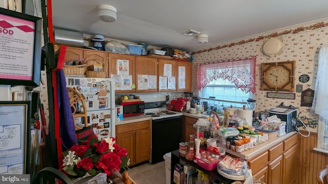 71 Shawmont Ln, Willingboro, NJ 08046 - kitchen with electric stove, black microwave, light countertops, brown cabinets, and wallpapered walls