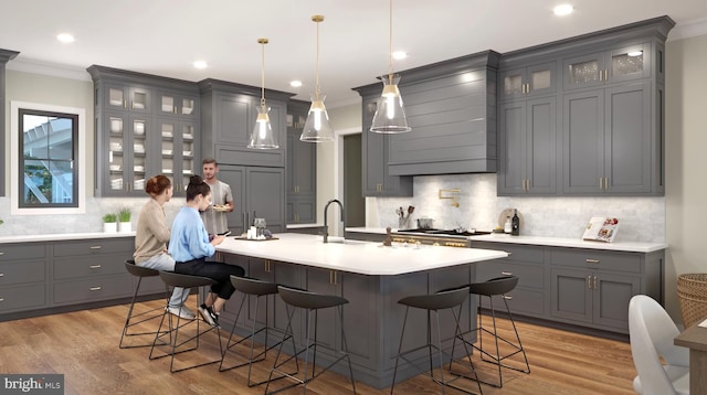 25826 Orchard Ter, Royal Oak, MD 21662 - kitchen with gray cabinets, ornamental molding, decorative backsplash, an island with sink, and a kitchen breakfast bar