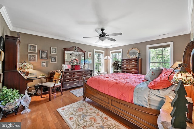 311 Deep Creek Dr, Seaford, DE 19973 - bedroom featuring multiple windows, wood finished floors, crown molding, and a ceiling fan