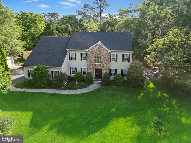 311 Deep Creek Dr, Seaford, DE 19973 - colonial house with a shingled roof, a front yard, and stucco siding