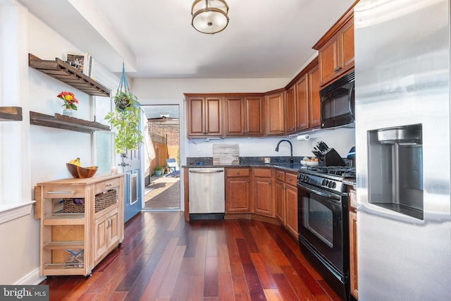 1238 N Mascher St, Philadelphia, PA 19122 - kitchen with black appliances, dark wood finished floors, a sink, and brown cabinets