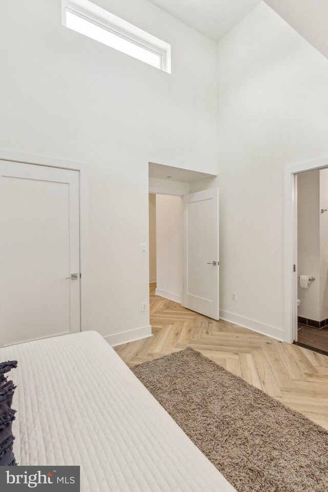 1214 Queen St NE Unit 2, Washington, DC 20002 - bedroom featuring a high ceiling, baseboards, and connected bathroom