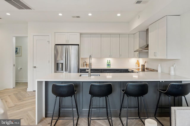 1214 Queen St NE Unit 2, Washington, DC 20002 - kitchen featuring stainless steel fridge with ice dispenser, white cabinetry, a peninsula, light countertops, and recessed lighting