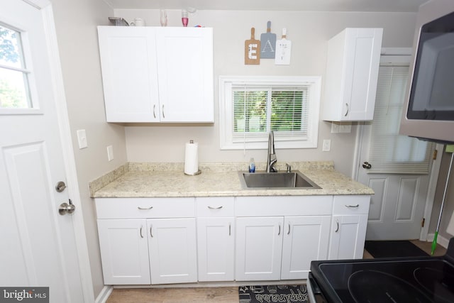 1675 Highland Ter, Saint Leonard, MD 20685 - kitchen featuring a sink, white cabinets, stainless steel microwave, and light stone countertops