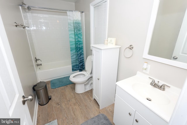 1675 Highland Ter, Saint Leonard, MD 20685 - bathroom featuring wood finished floors, toilet, vanity, and shower / bathtub combination with curtain