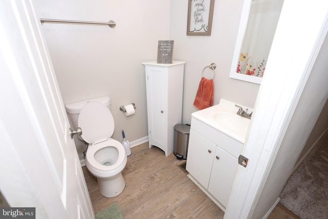 1675 Highland Ter, Saint Leonard, MD 20685 - bathroom featuring wood finished floors, toilet, vanity, and baseboards