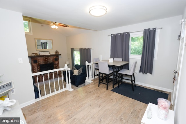 1675 Highland Ter, Saint Leonard, MD 20685 - dining room featuring a ceiling fan, wood finished floors, plenty of natural light, a fireplace, and lofted ceiling