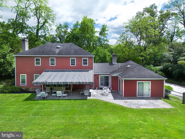 5 Salem Way, Malvern, PA 19355 - back of property featuring a chimney, a patio area, a yard, and view of scattered trees