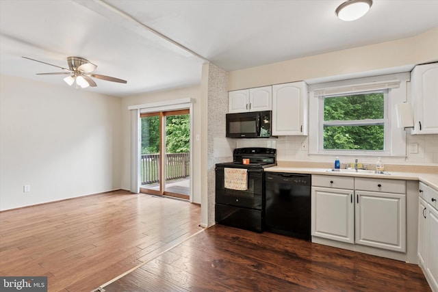 2425 W Colonial Dr, Upper Chichester, PA 19061 - kitchen featuring black appliances, a sink, healthy amount of natural light, and tasteful backsplash