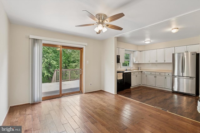 2425 W Colonial Dr, Upper Chichester, PA 19061 - kitchen featuring freestanding refrigerator, white cabinetry, a ceiling fan, light countertops, and dark wood-type flooring