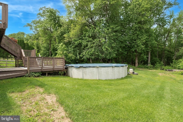 2425 W Colonial Dr, Upper Chichester, PA 19061 - view of green lawn with stairway, a wooden deck, and a covered pool