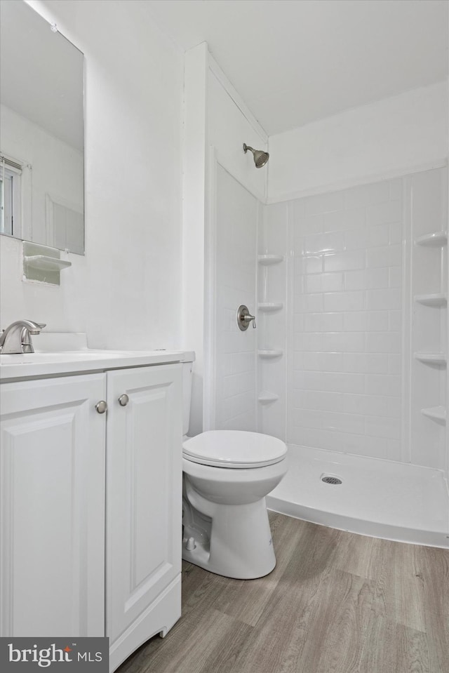 2425 W Colonial Dr, Upper Chichester, PA 19061 - full bathroom featuring wood finished floors, tiled shower, toilet, and vanity