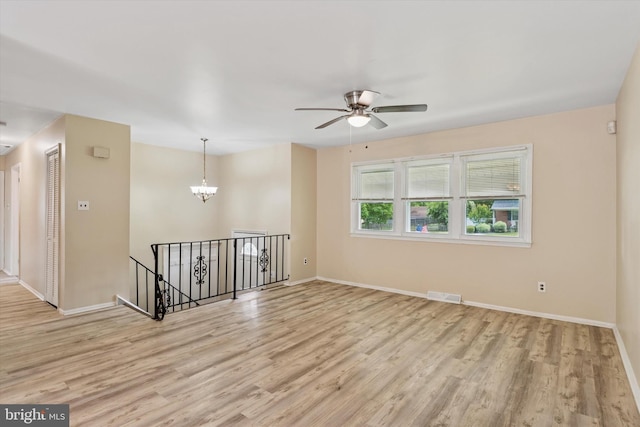 2425 W Colonial Dr, Upper Chichester, PA 19061 - empty room featuring wood finished floors, a chandelier, baseboards, and ceiling fan